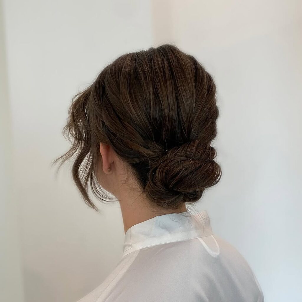 Top 19 Claw Clip Hairstyle Ideas: Trendy and Effortless Looks for Every Occasion 2 Low Bun with Face-Framing Tendrils